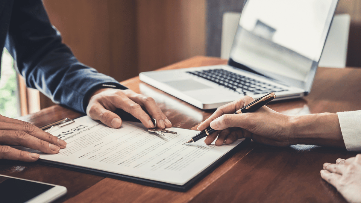 Person reading and signing a contract